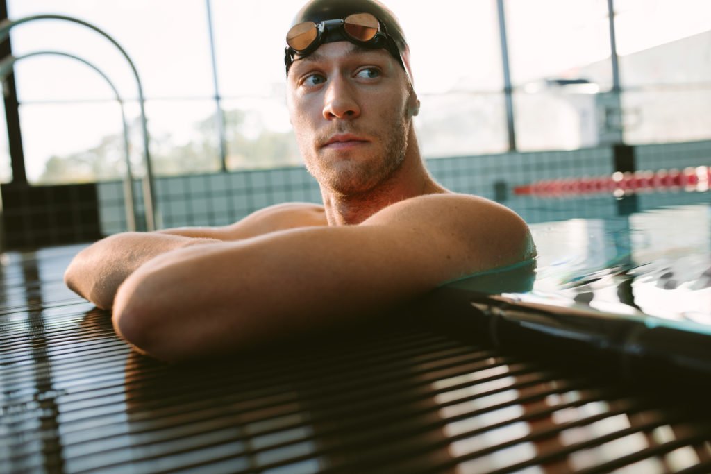 Home 17 male swimmer resting on the edge of swimming pool 2022 02 02 05 05 44 utc