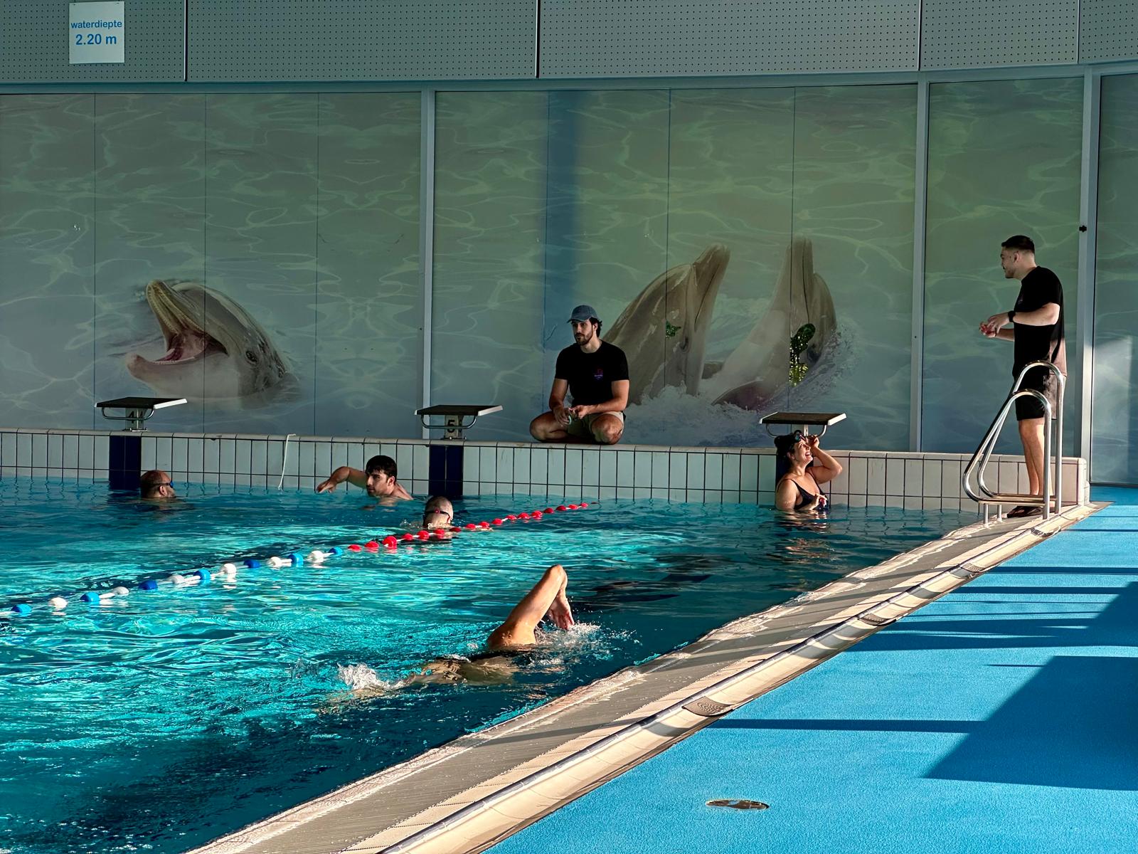 Swimming instructor teaching at poolside