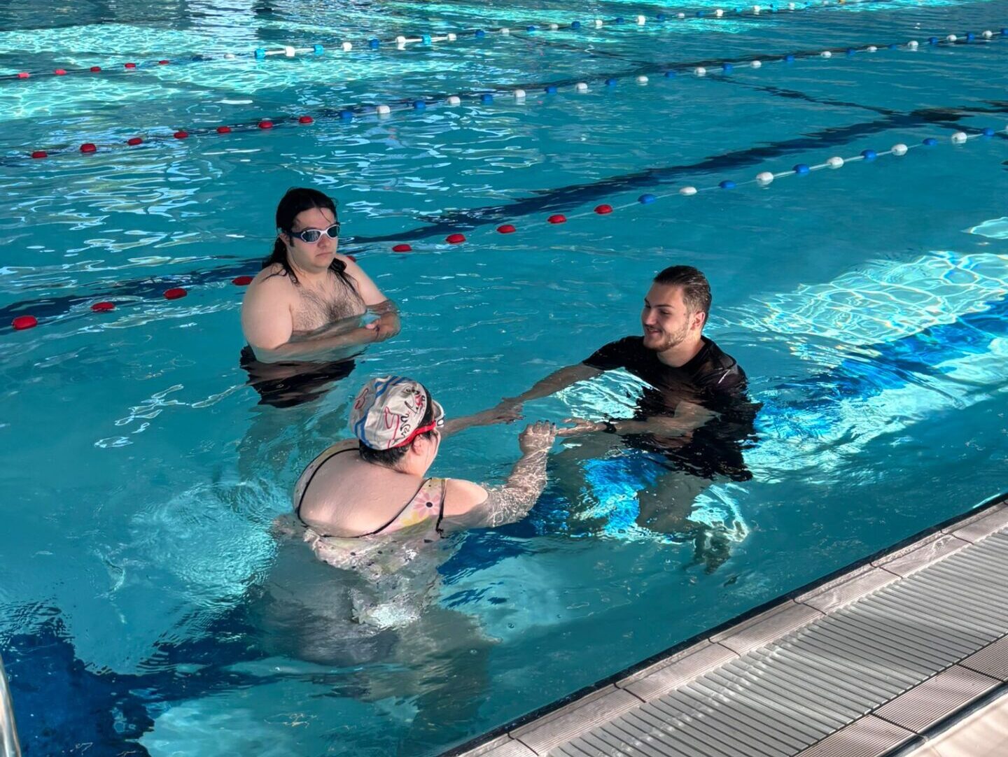 Adult swimmer getting comfortable in the deep water during beginner lesson