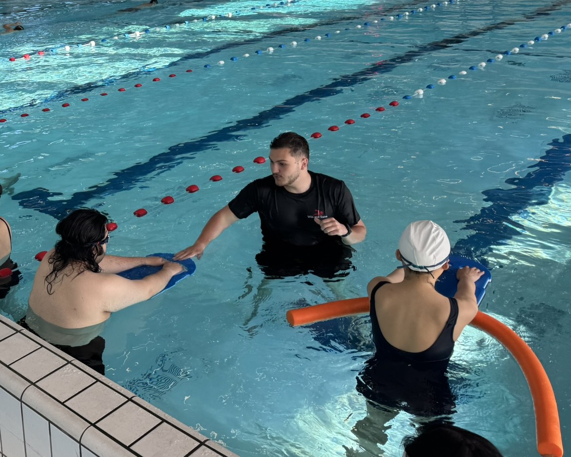 Adult overcoming fear of water during aquaphobia swimming lesson in Amsterdam